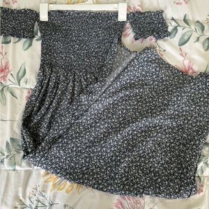 A navy blue and white floral pattern long strapless dress with thigh slit.